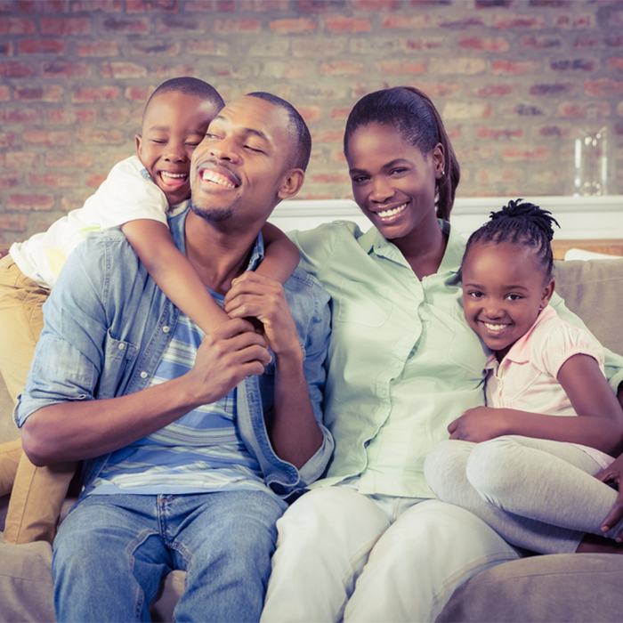 Smiling family on couch